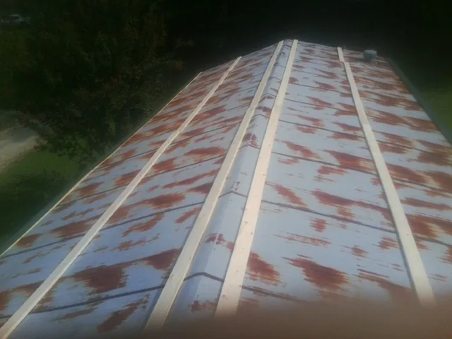 Rusted metal roof panels with new wood purlins before replacement — Storm Damage Roof Repair in Eatontown by Roofing Brothers
