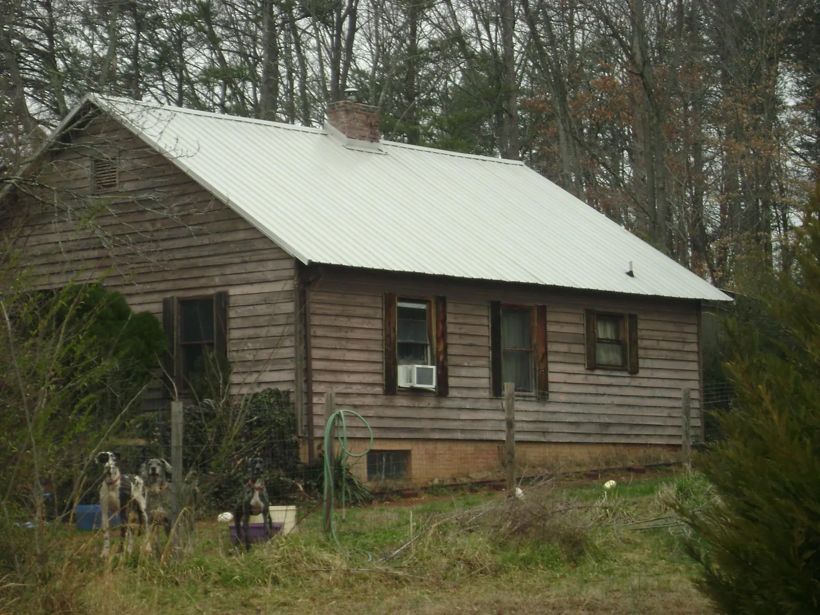 White metal roof on an old wood sided farmhouse, from a Metal Roof Installation job in Eatontown